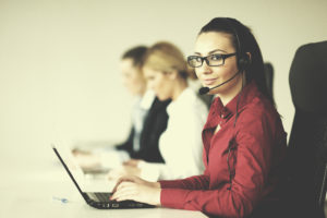 business woman talking to client on headphones