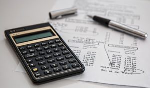 Image of a calculator and a finance report