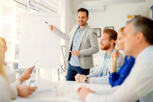 Men teaching to his colleagues