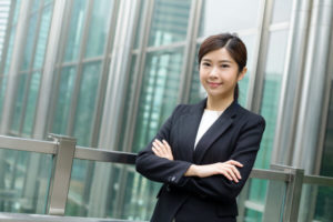 Women smiling while crossing her arms together