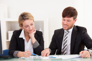 Female and Male co workers going over data together