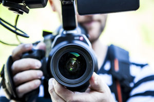 Man pointing his camera in the frame