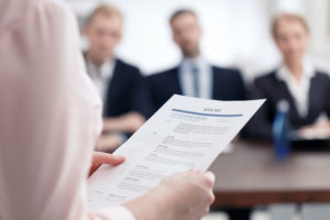 Women holding resume in hands