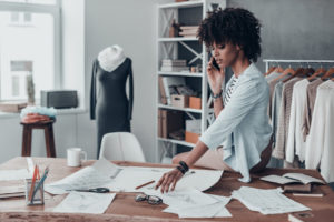 Women on the phone while looking at designs