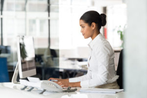 Secretary typing on desk